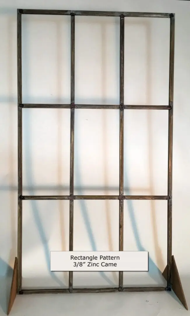 Rectangular metal grid pattern made of 3/8" zinc came, standing upright with supports on each side.